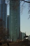 View of a mounted figure in relation to tall buildings